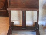 a wooden easel with a wooden seat on a wooden floor