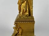 an image of a gold statue of a woman on a pedestal