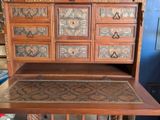 a wooden desk with drawers and drawers on top of it