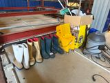 several pairs of shoes are lined up on a rack in a garage