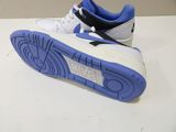 a pair of white and blue shoes on a table