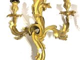a gold colored candle holder with two candles on it