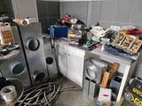 a kitchen with a lot of clutter and tools on the counter