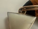 a small metal object with a triangle on top of it