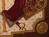 a picture of a red and gold scarf with a sword on it