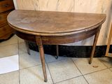 a small table with a wooden top on a tiled floor