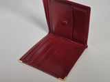 a close up of a red leather wallet on a white surface