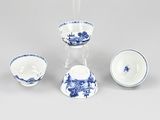 three pieces of blue and white porcelain on a white surface