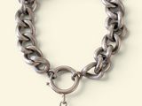 silver chain bracelet with a silver ball charm on a white background