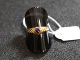 une image représentant une bague ornée d'un cœur, posée sur une table