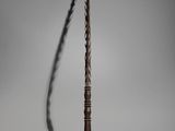 a long stick with a long tail on a white surface