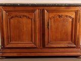 a wooden cabinet with two doors and a marble top