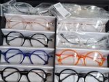 many pairs of glasses sitting in a box on a table