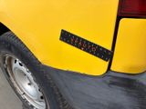 a yellow truck with a sticker on the back of it