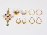 a group of rings and ear rings on a white surface