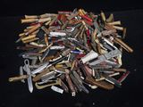 many different types of knives on a black surface
