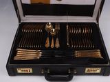 a black case with silverware in it on a white surface