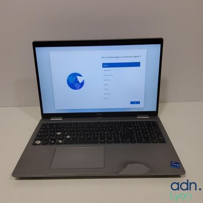 an open laptop computer sitting on top of a white table