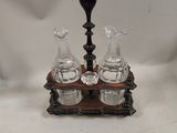 two glass decanters sitting on a wooden stand