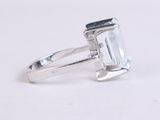 an image of a ring with a white topazt stone on it