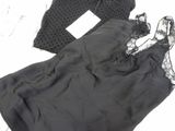 a black dress and a pair of shoes on a white surface
