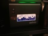 a coffee maker with a green light on top of it