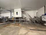 an image of a factory with a conveyor belt in the middle of the room