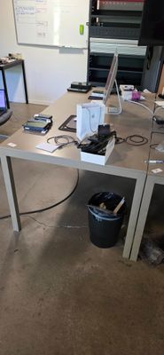 a desk with two laptops and a monitor on it