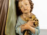 a statue of a child holding a skull and a statue of a man