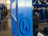 a blue sign that says l on the side of a building