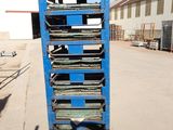 a blue cart that has a lot of books on it