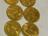 a lot of gold coins sitting on a white surface