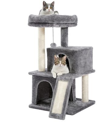 deux chats assis au sommet d'un arbre à chat, sur lequel se trouve un autre chat