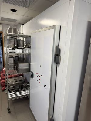 a kitchen with a refrigerator, dishwasher, and dishwasher in it