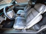 the interior of a car with leather seats and a steering wheel