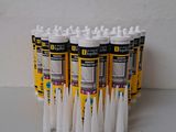 six tubes of toothpaste on a white table