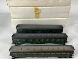 several different types of toy trains are sitting on a white surface