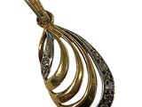 a close up of a gold pendant on a white background