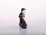a figurine of a woman sitting on a horse