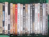 a lot of dvds in a green basket on the shelf