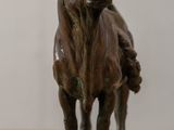 a statue of a bull standing on a wooden table