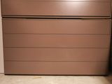 a brown refrigerator sitting in the corner of a room