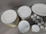 a lot of plates and bowls that are sitting on a table