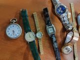 many different types of watches on a wooden table