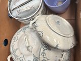 a cardboard box filled with plates and bowls
