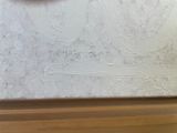 a picture of a clock on the wall of a building