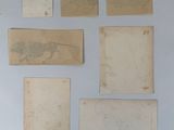 several pieces of old paper are arranged on a white surface