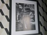 a black and white photo of a car on a wall