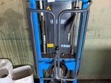 a picture of a blue lift truck in a garage