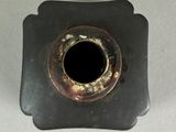 an old metal object with a hole in the middle of it